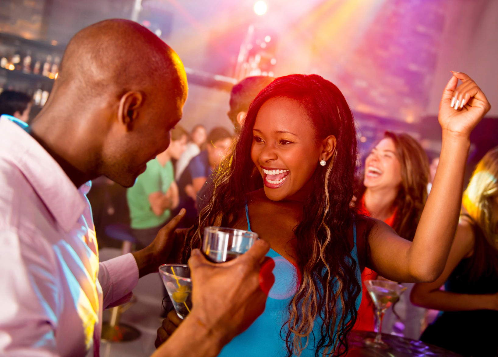 Happy couple clubbing at a nightclub having fun dancing